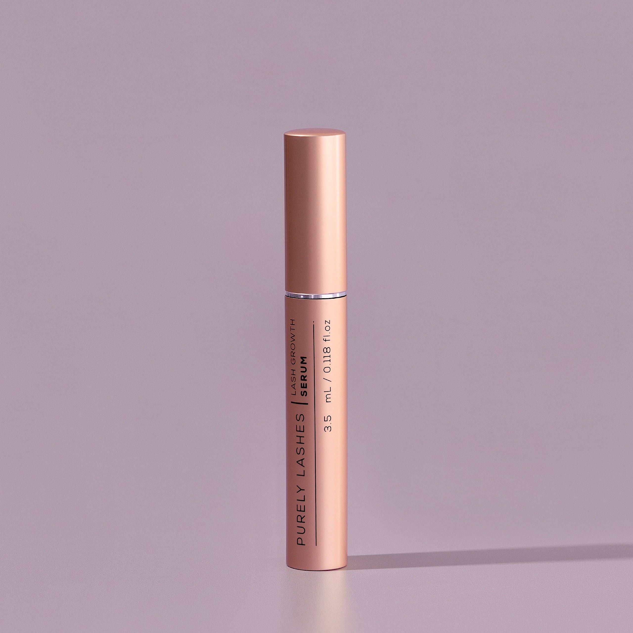 Lash Serum bottle on a musk pink background